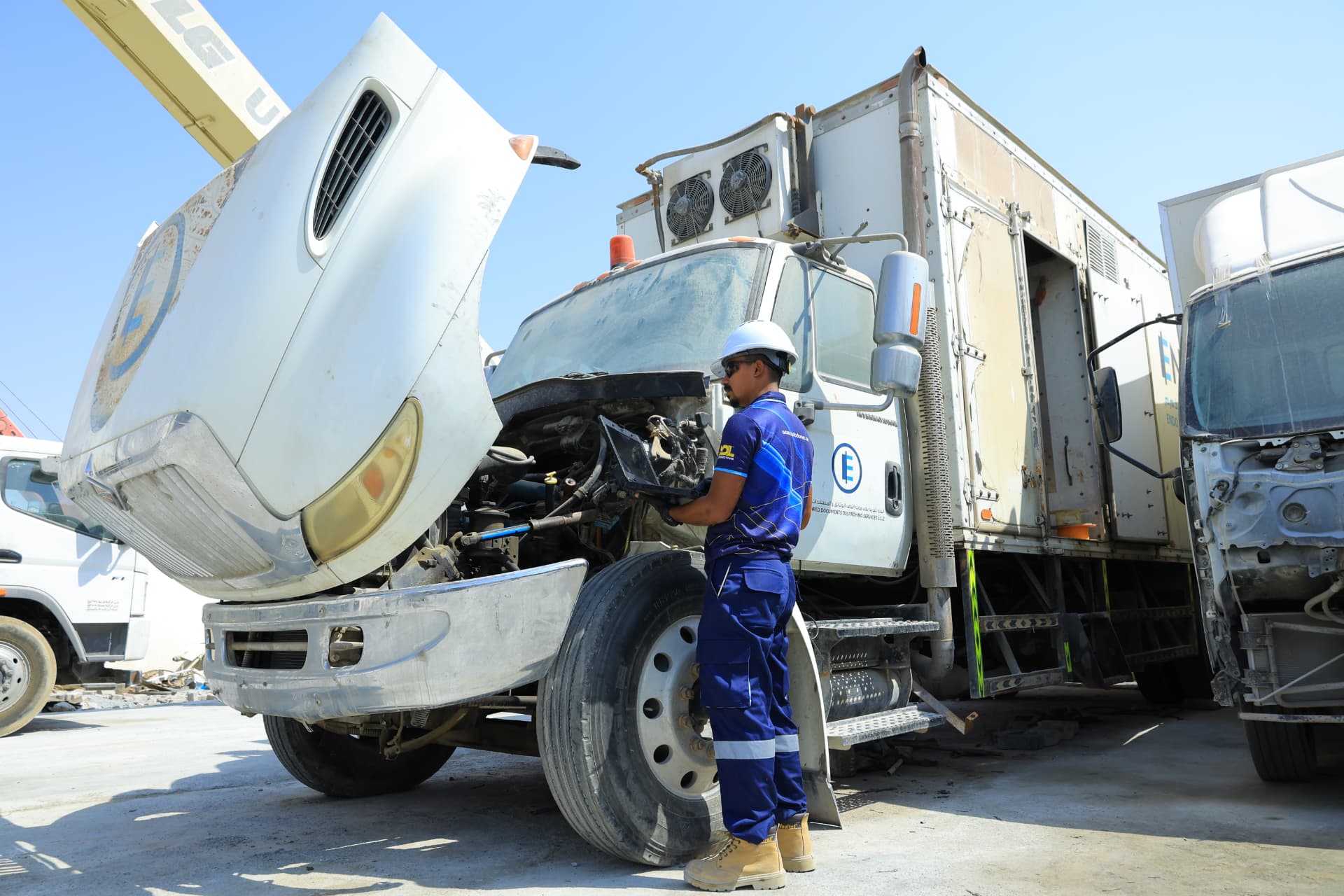 Engineer repairing a vehicle electronic control unit circuit board